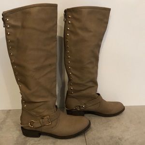 Tall brown buckled boots